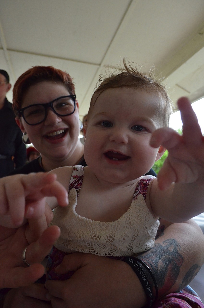 Amber Phillips holds her 1-year old daughter Zoe at the celebration.
