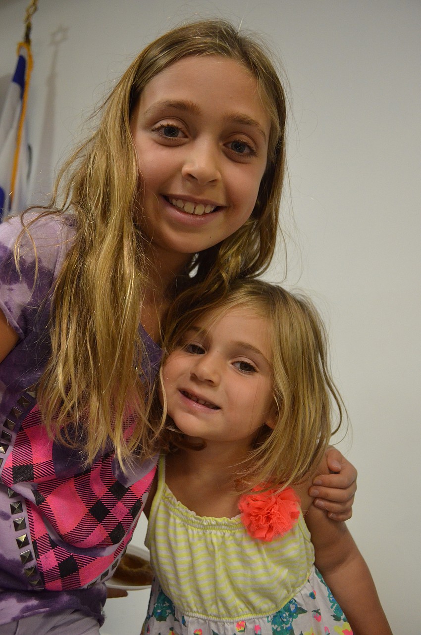 Carly Mallitz, 9, hugs her little sister Dani, 3.