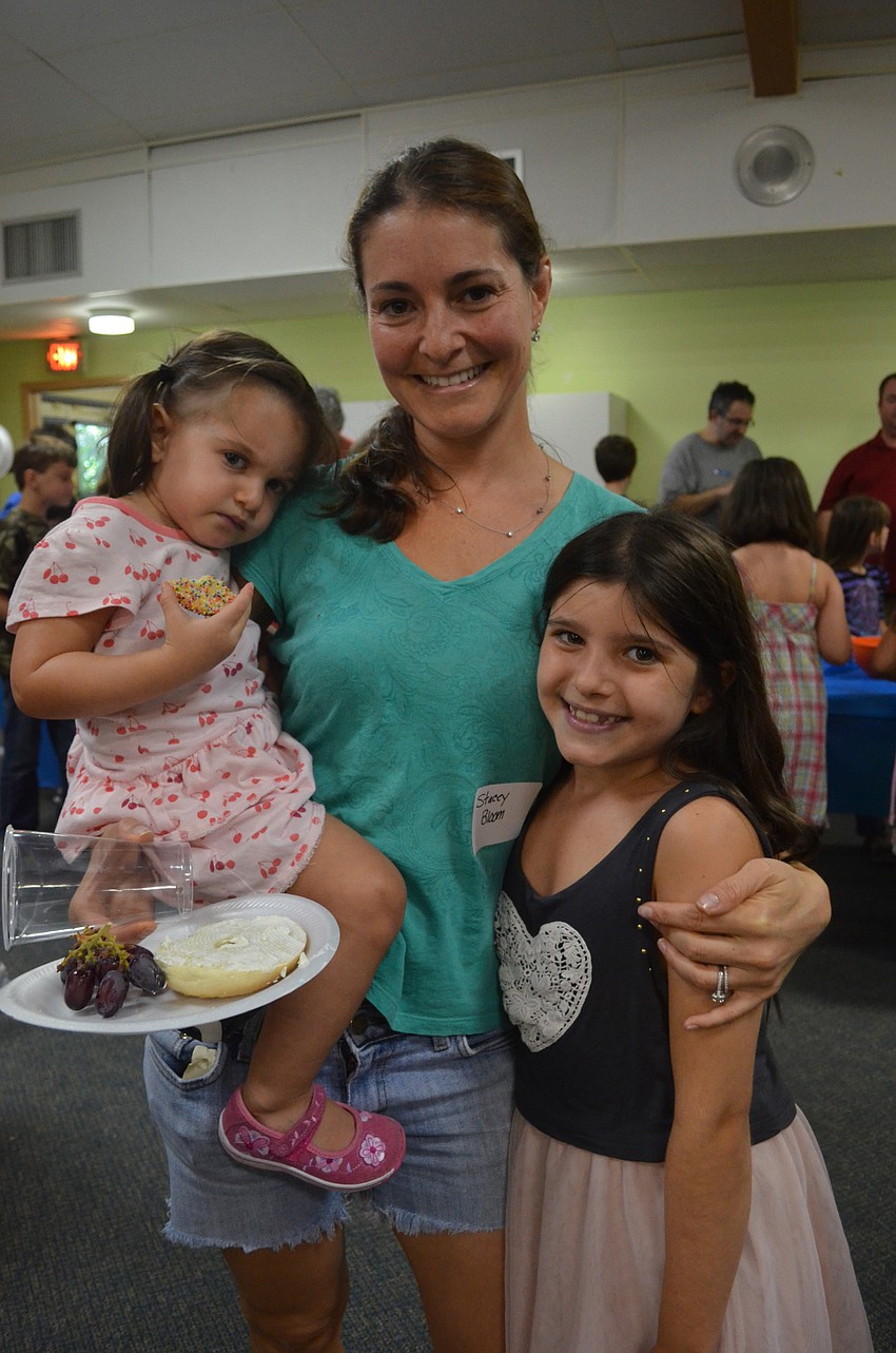 Stacy Bloom with her daughters Phinley, 2, and Riley, 8