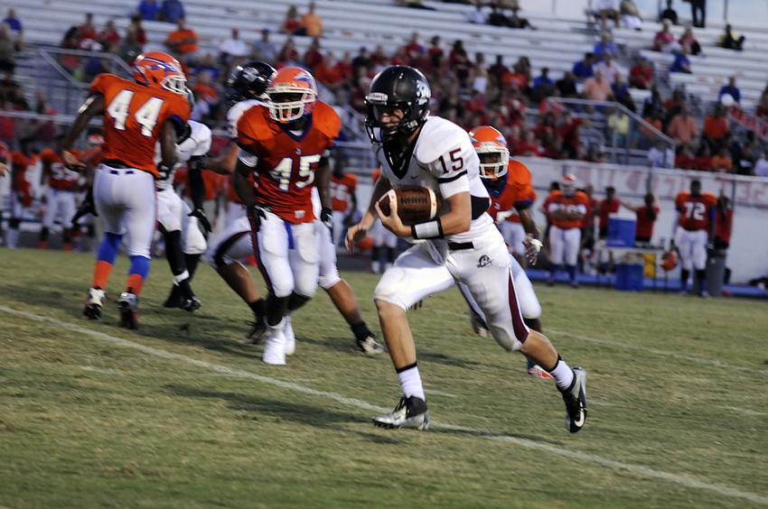 Braden River quarterback Dusty Peebles carries the ball for a first down.