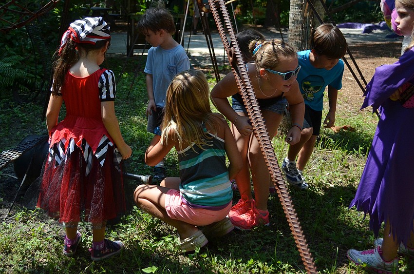 The children use treasure map clues on the treasure hunt.