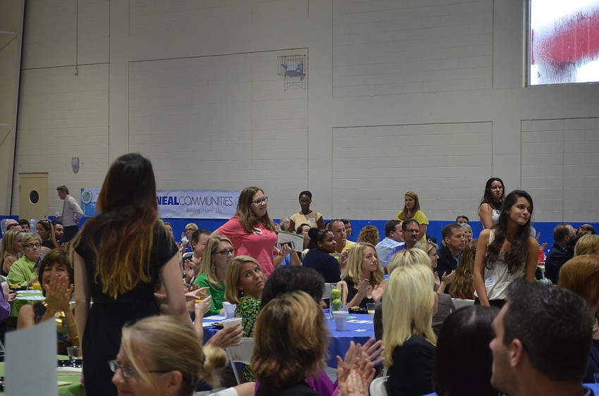 Community Youth Development leaders stand to be recognized at the breakfast.