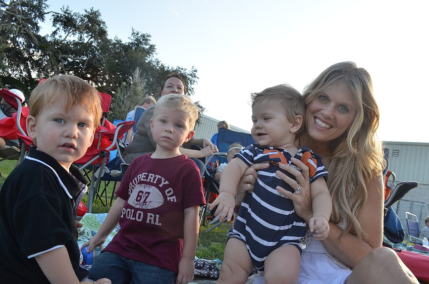 Asher Wyckoff, 2, his cousin Nicholas Jackson, 3, little brother Brooks, 8 months and mom Christine enjoy the evening playing on the field.