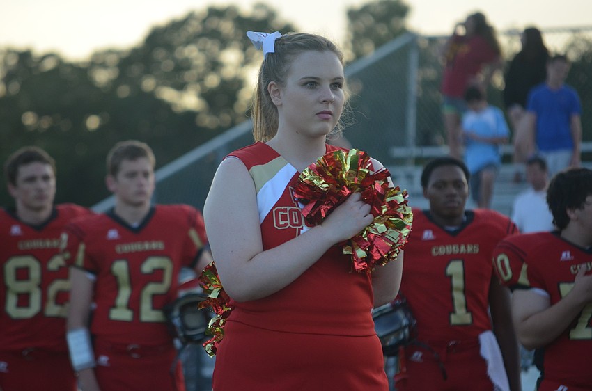 Meghan Grabowski, 16, salutes the flag during the National Anthem.