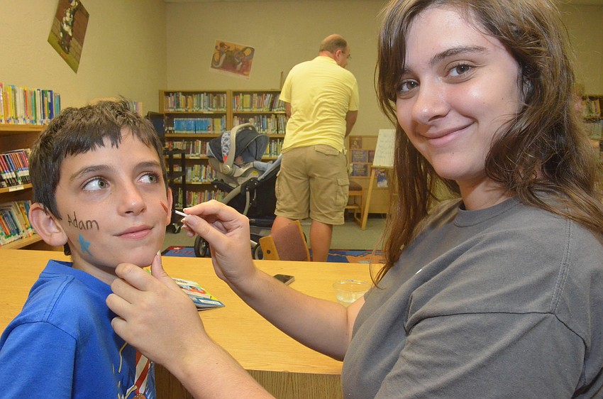 Lilly Bassil, 15, paints her brother 9 â€“ year old brother Adamâ€™s face.