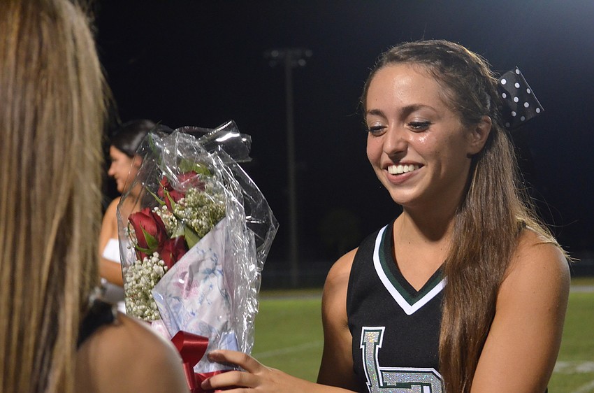 Homecoming queen Marina Masterson receives flowers after winning.