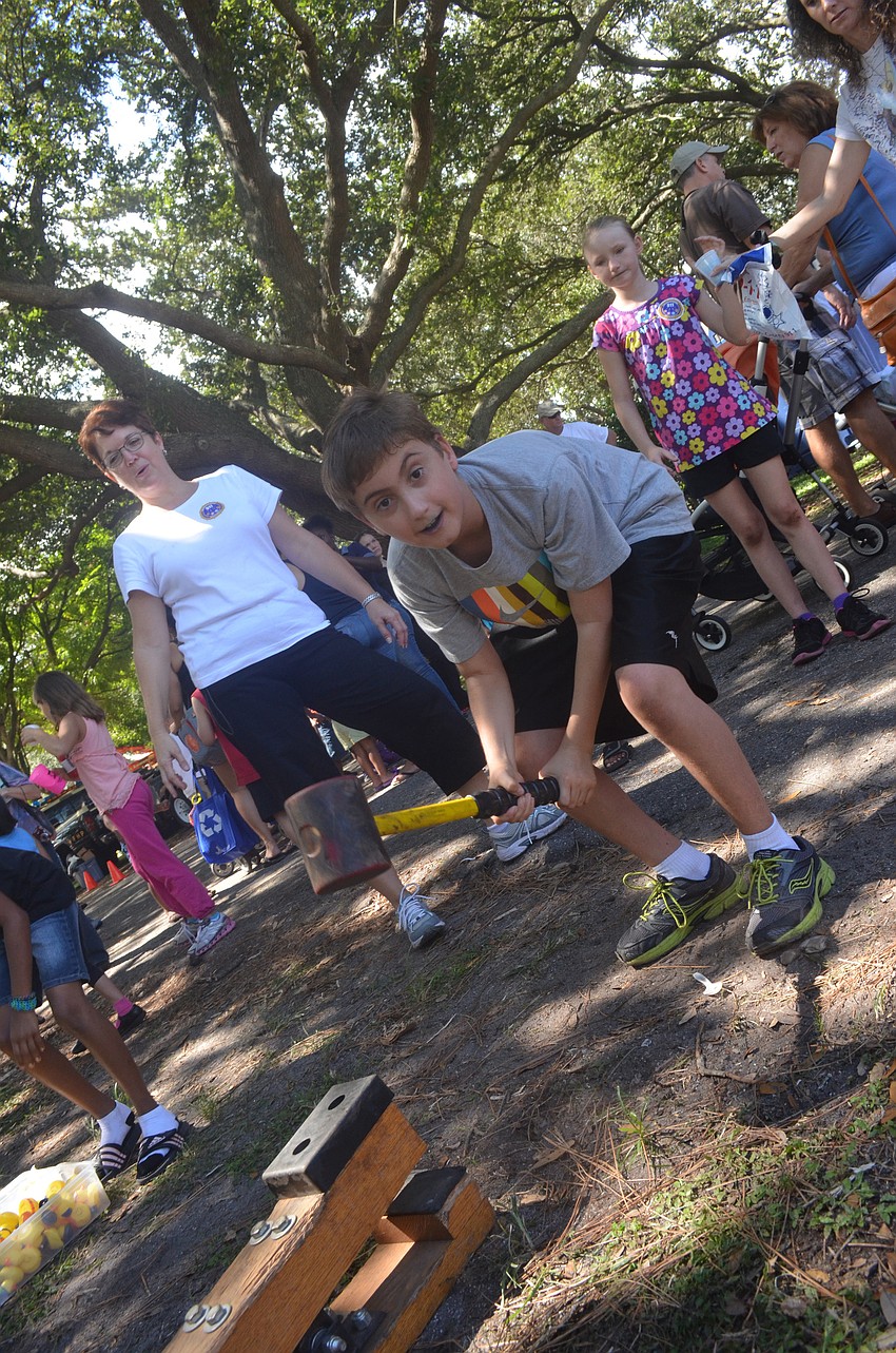 Caleb Brown, 10, tests his strength at the hammer game.