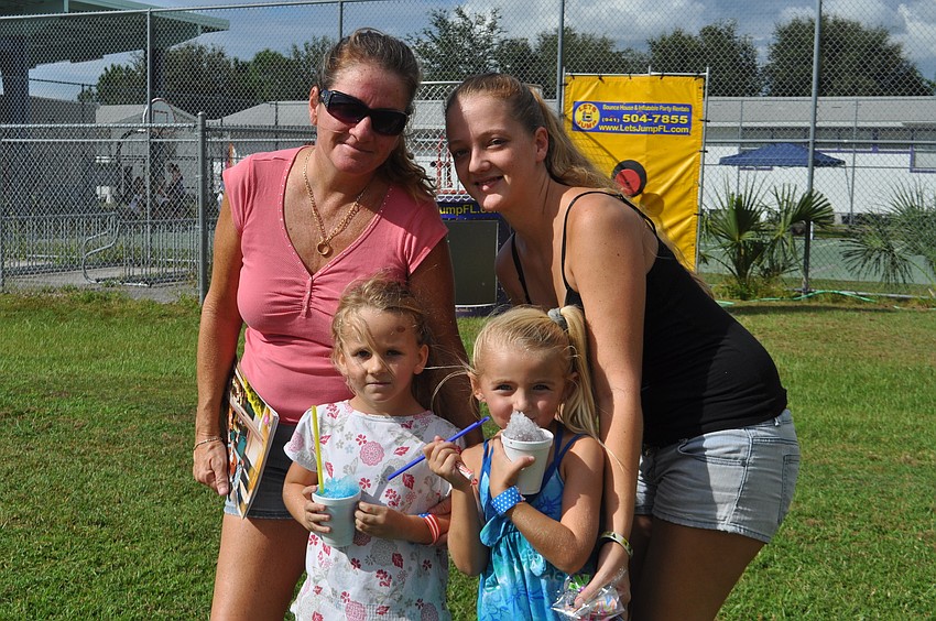 Vertie Hayward, Ryelee Carpenter, Sheyenne Carpenter and Cassandra Hayward enjoy snow cones and the sun