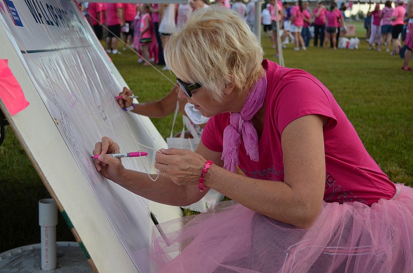 Deb Van Schoick writes a message on the Wall of Hope.