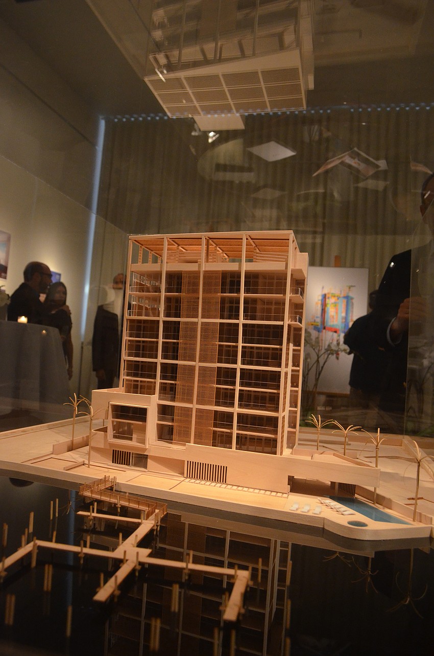 Developers Michael Adams and Jonathan McCague and architect Guy Peterson present a model of the future luxury condominiums.