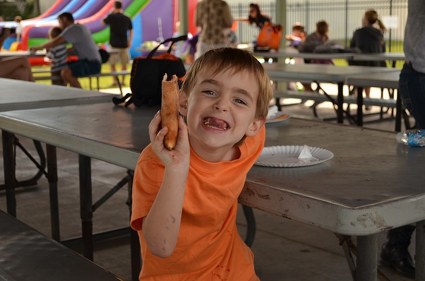 Max Rusnak enjoys his pizza at the YMCA Fall Festival.