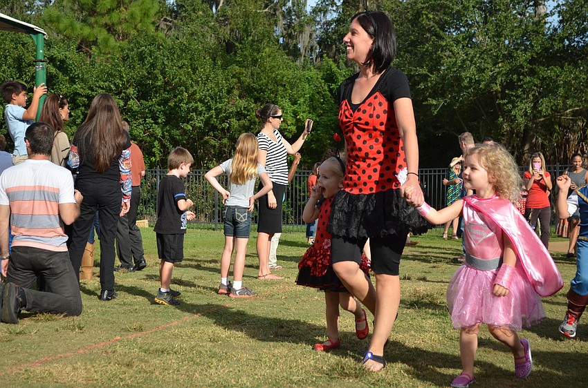 Pre-school teacher Dina Sacchi walks with her students in the parade.