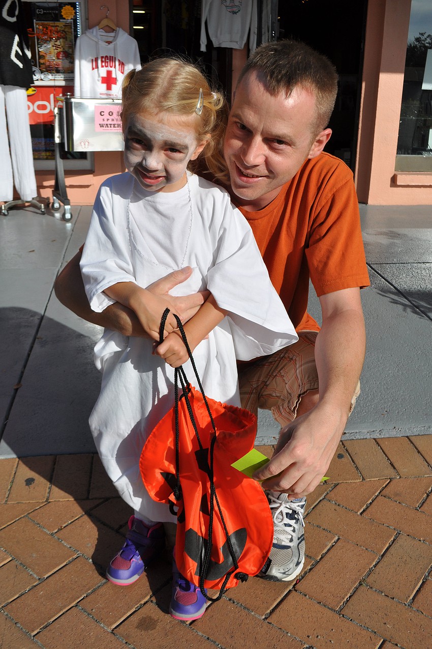 Annabel, 3, and her father Richard Deal enjoy trick-or-treating.