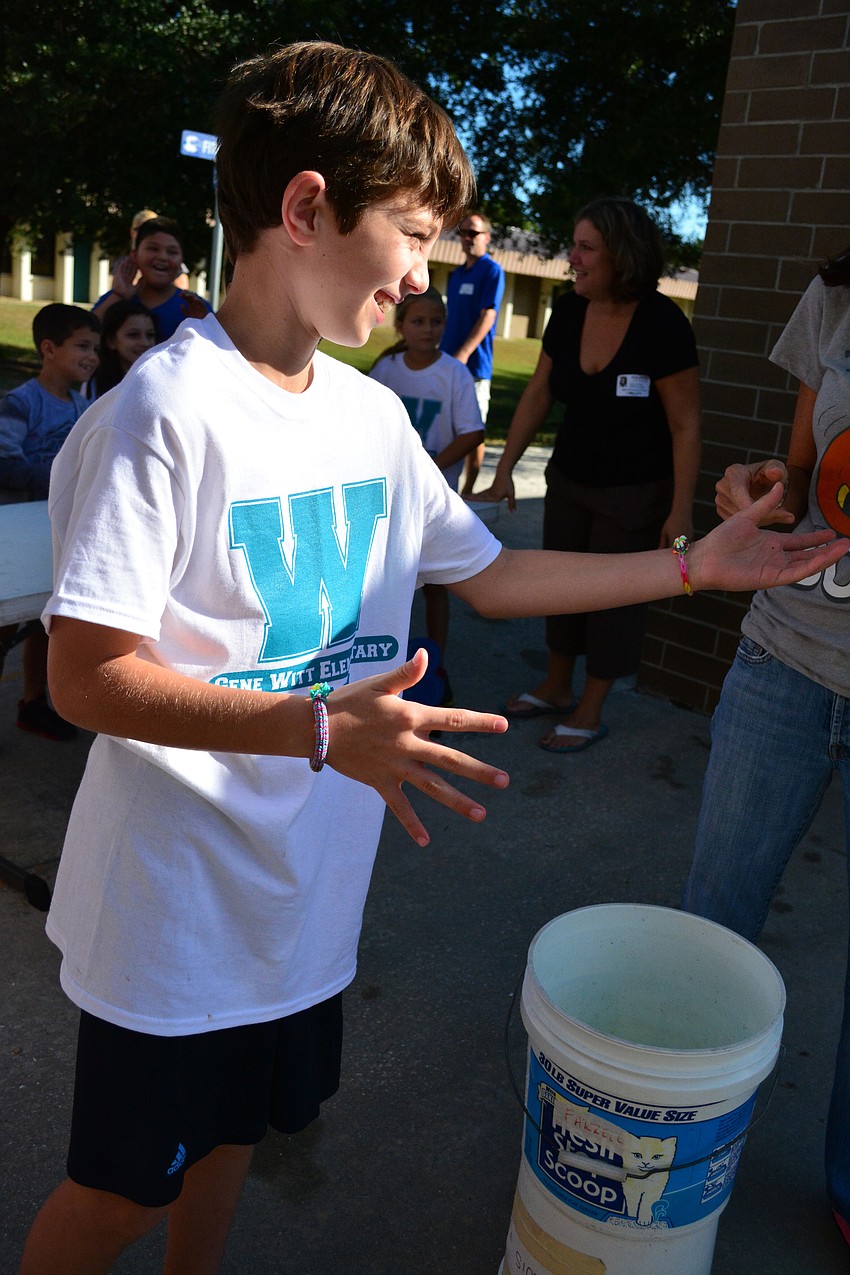Drew Clark, 9, earned cheers for knocking a teacher into the dunk tank.
