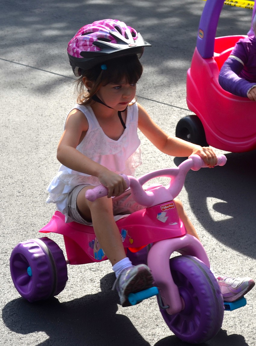 Mya Williams, 3, peddles as fast as she can.