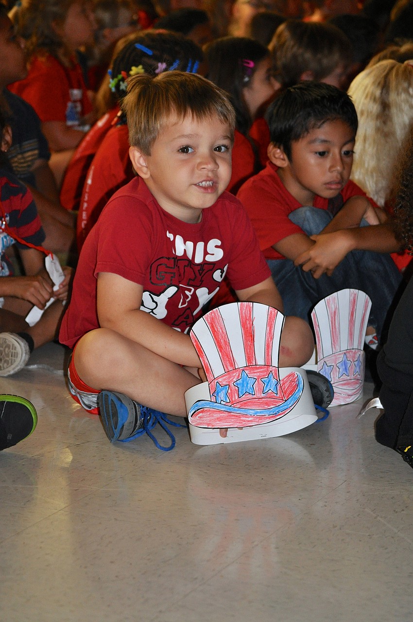 Kaleb Guy, 5, shows off his decorated paper hat.