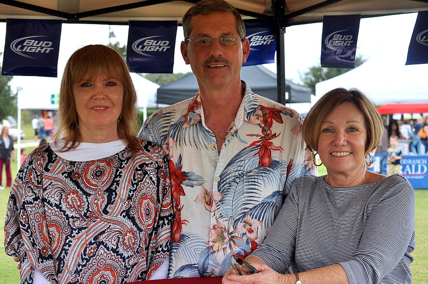 Candice and Bruce Kreiner and Eileen Bradicich enjoy the event's food and drinks.