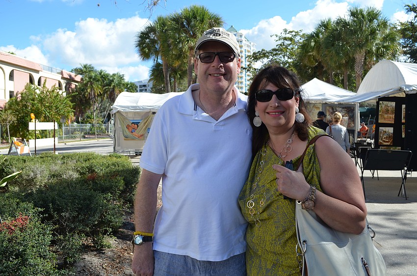 Julie and Victor Abrams from London, England walk around the Fall Fine Art Festival Saturday, Nov. 23.