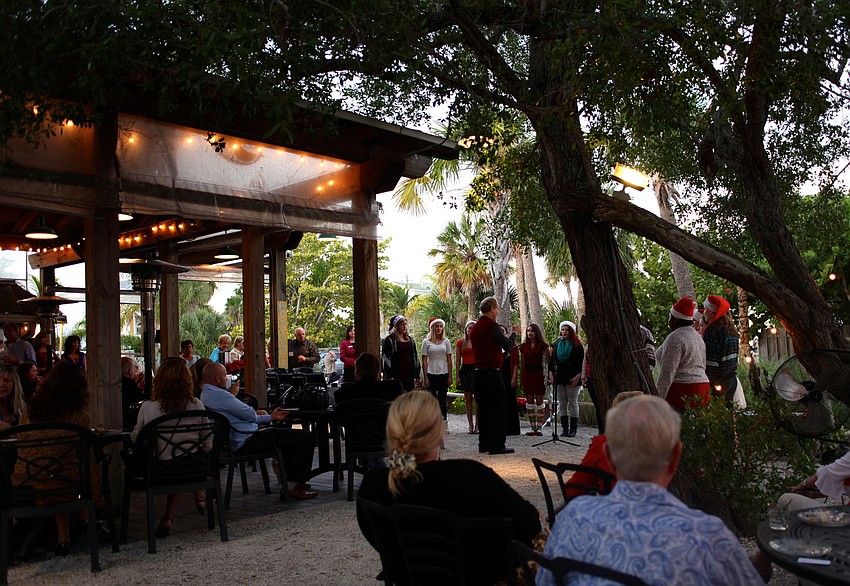 The Sarasota High School Chamber Choir sings for the crowd attending the Chamber Holiday Party at MarVista.