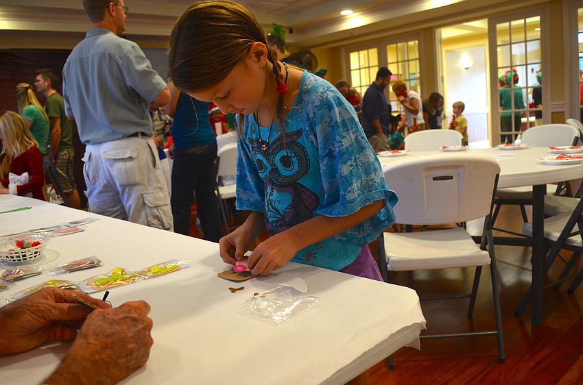 Isabella Silverio, 8, puts together a reindeer.