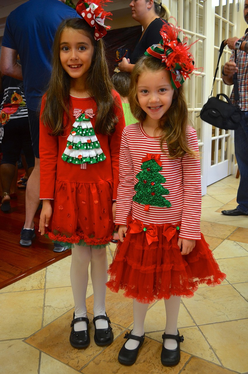 Alexi Haider, 7, and her sister Kali, 5, play matching dress up.