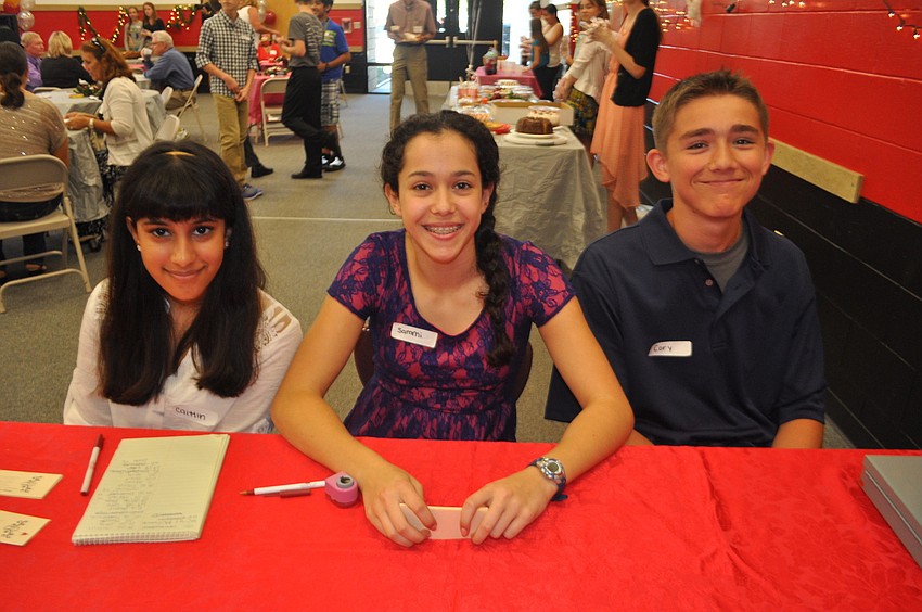 Caitlin Bhagwandeen, Sammi Zelitt and Cory Albrecht check in visitors.