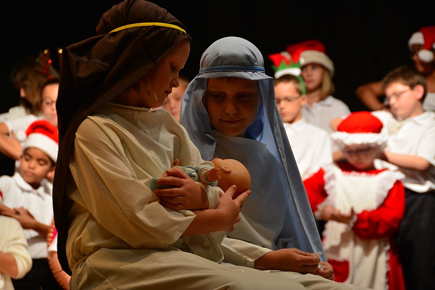 Lucy Milner and Matthew Talbot portray Mary and Joseph during one song.