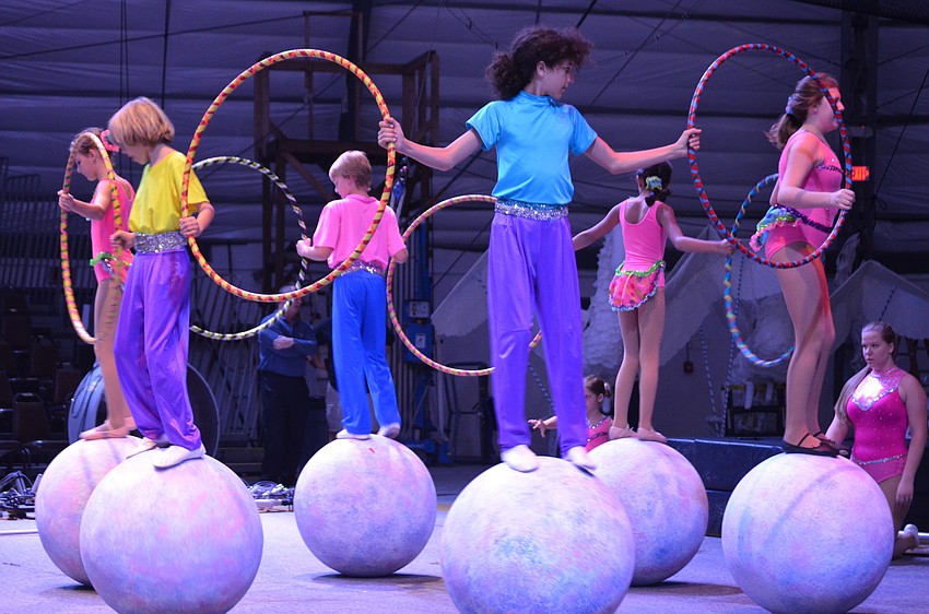 Sailor Circus performers balance atop large balls