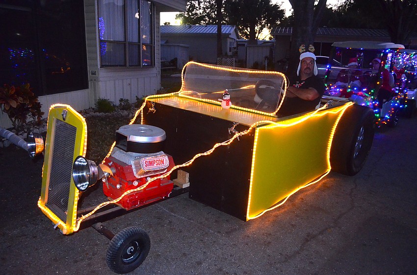 Robert Donnelly shows off his hot rod golf cart while waiting to drive around the Horseshoe Cove community.