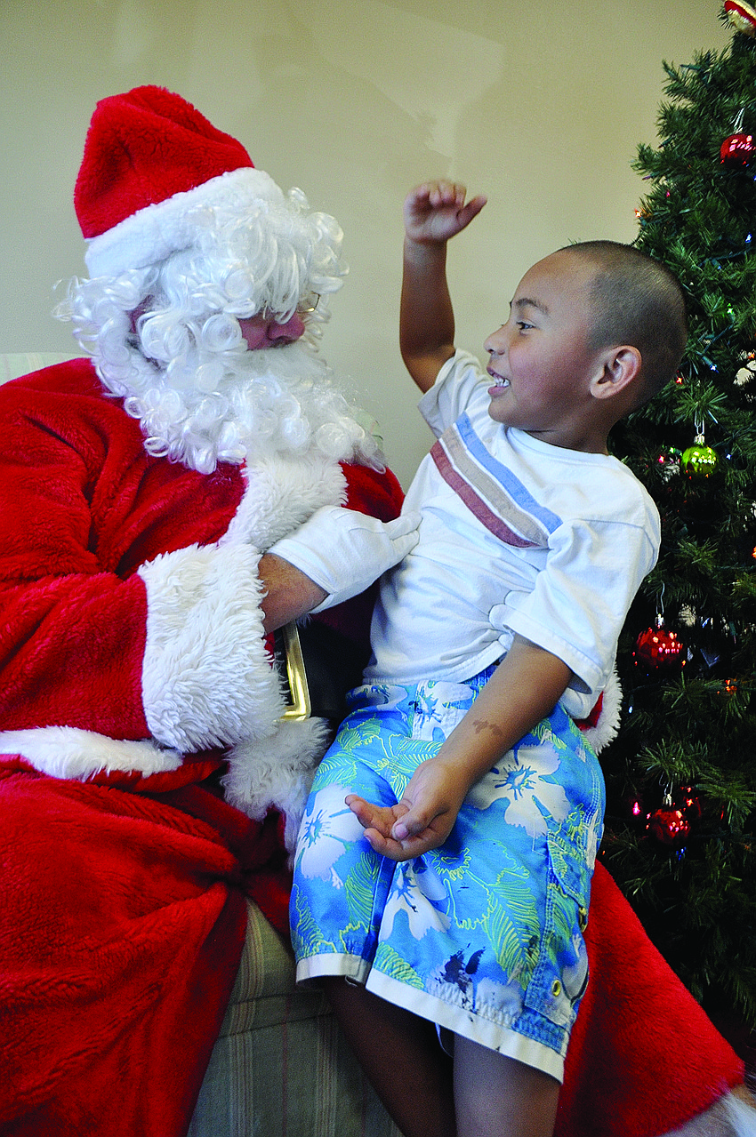 Avery Gonzalez, 3, shares his Christmas wish list with Santa Dec. 8 at the Lakewood Ranch YMCAâ€™s Sledding with Santa event.