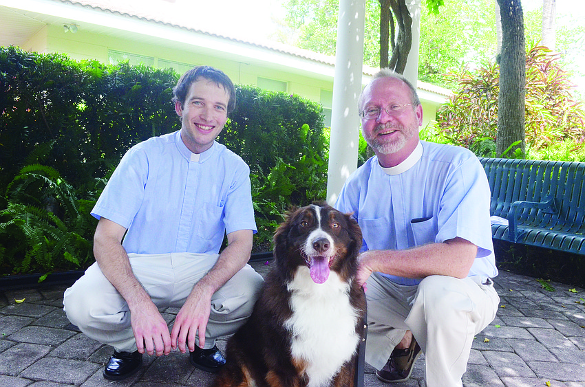 Vicar James Henricks and the Rev. Mark Bernthal bless Australian shepherd Jack Oct. 6 at St. Armands Key Lutheran Church's Blessing of the Animals.