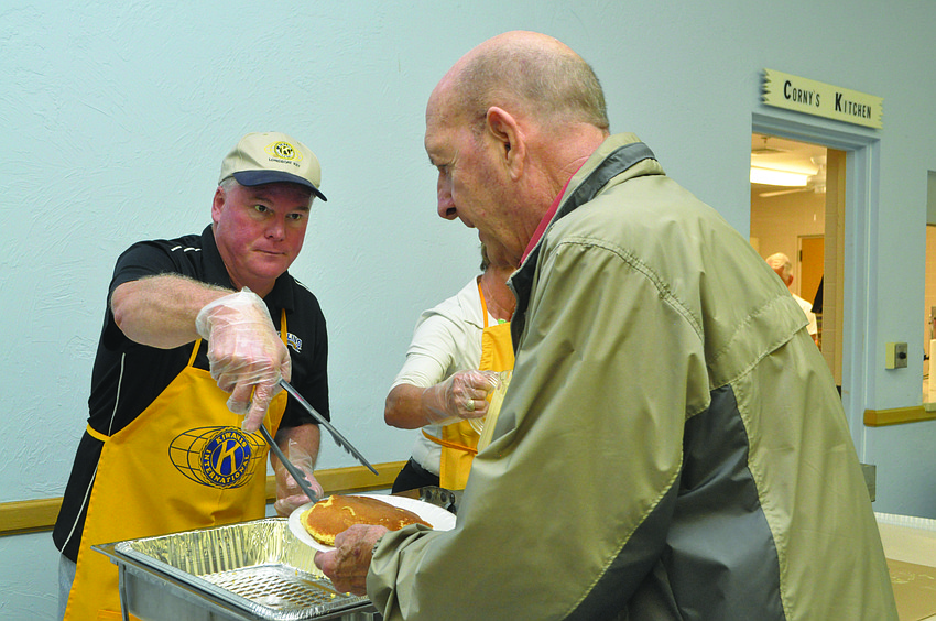 Jack Brill serves Rick Williams a stack of hotcakes at the Kiwanis Club of Longboat Key's annual pancake breakfast March 23, which drew approximately 500 people. 6. Public Works employee Jason Schmidt, with his grandmoth