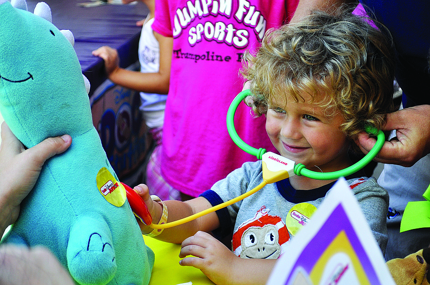 Hunter Montague listens closely to his friend, Dinorex's, heartbeat, Sept. 28, at the annual 