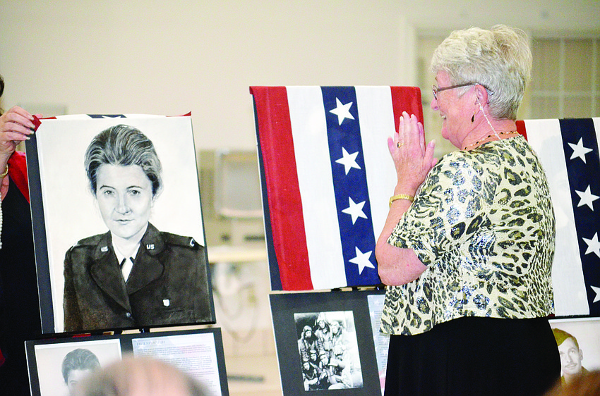 Ellie Neuwirth reacts to the unveiling of a portrait of her from her days in the Air Force during the Senior Friendship Centers' Portraits of Service event Nov. 9. Neuwirth was 27 years old when she joined the Air Force.
