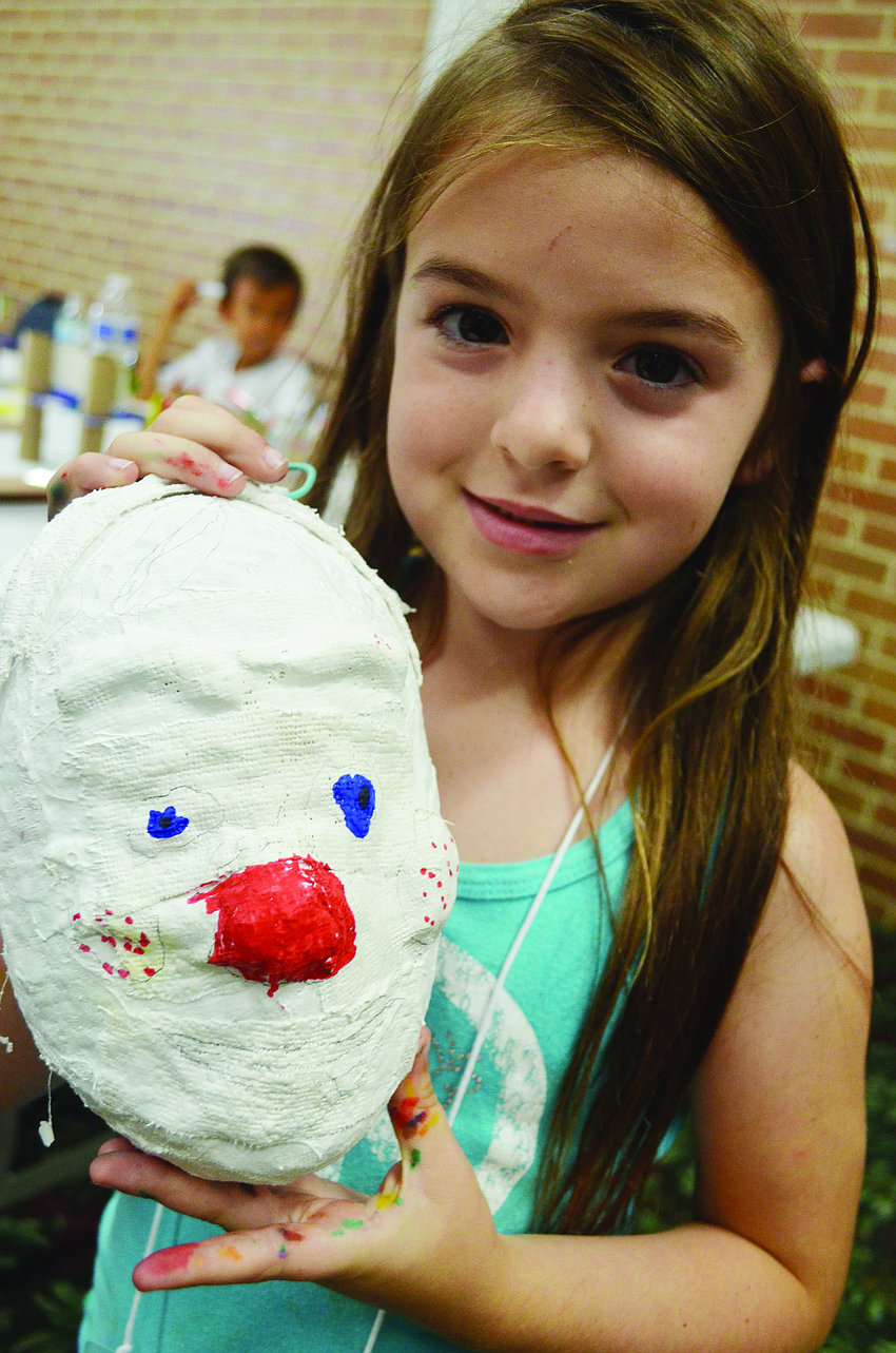 Luci Perales, 6, shows of her Renaissance-inspired mask at the Marie Selby Gardens Summer Camp Lookout's first session, called That's Amore! June 11.