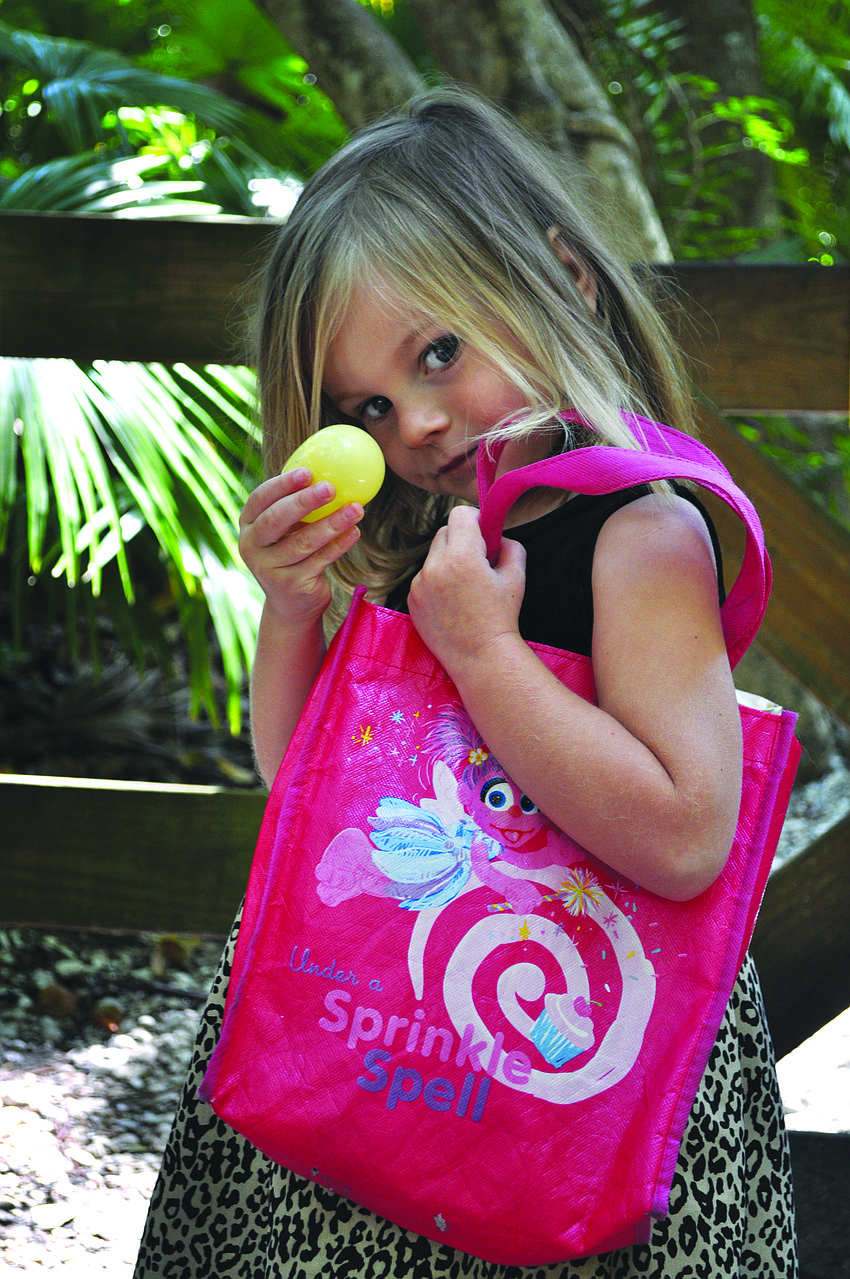 Lily Robbins shows off an egg she found March 29, at the Jungle Garden's Easter egg hunt.