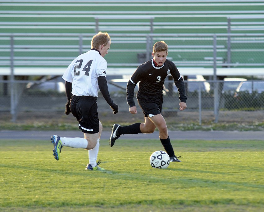 Lakewood Ranch forward Ryan Sollazzo looks to push the ball past Braden River sophomore Domenic Aluise.