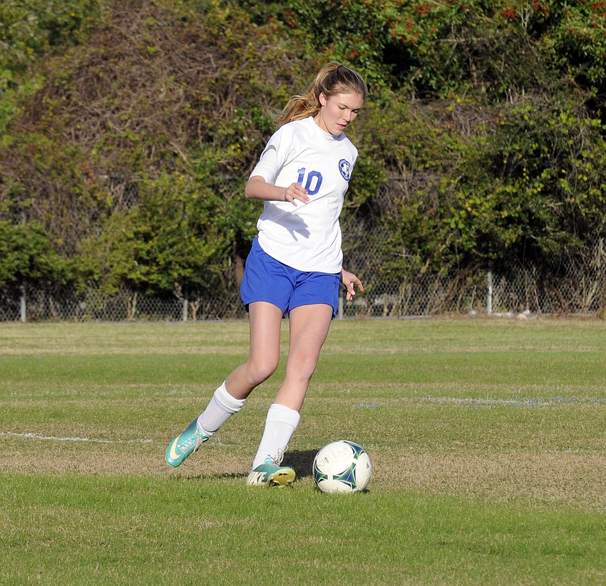 SMAâ€™s McKenna Jackson pushes the ball up the field for the Lady Eagles in the first half.