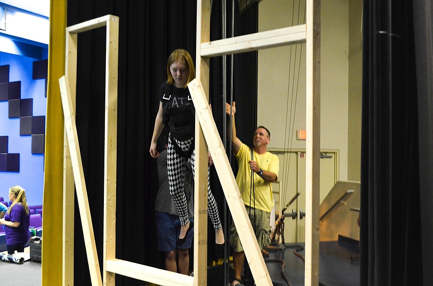 Father Steve Macejak hoists his daughter Bailey Macejak (Peter Pan) into the air