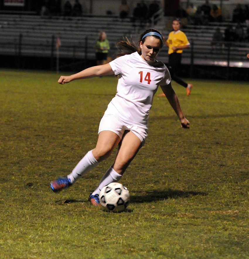 Cardinal Mooney senior midfielder Hanna Macdevitt maneuvers the ball down the field in the first half.