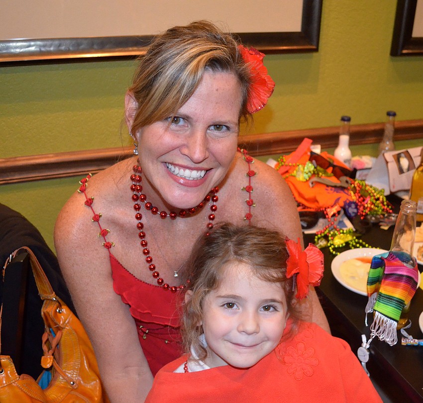 Paddi Juliano and her daughter, Isabella, 5, are the ladies in the red.