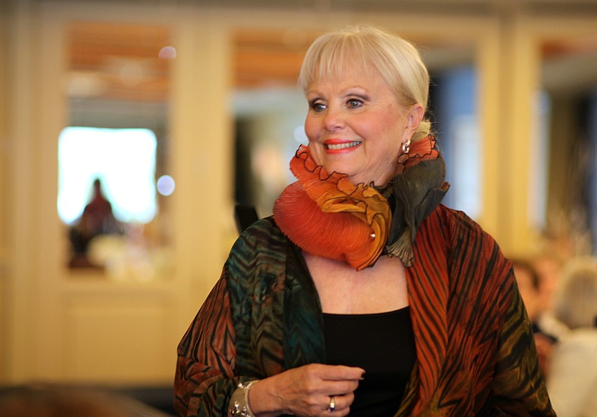 Linda Heckenberg models a scarf that complements her jacket.