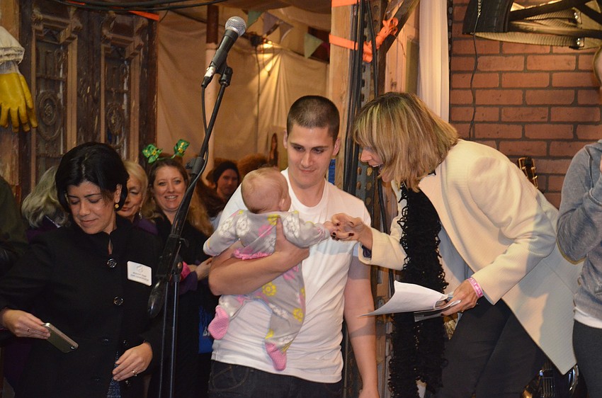 Commissioner Suzanne Atwell says hello to Addalyn Oâ€™Leary before introducing the family.