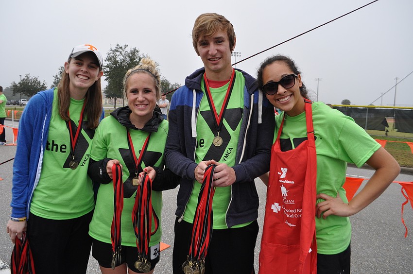 Bayside Community Church's 24/7 School of Ministry students Paige Rollins, Maria Haselbauer, Noah Baggett and Stephanie Sanchez pass  out metals.