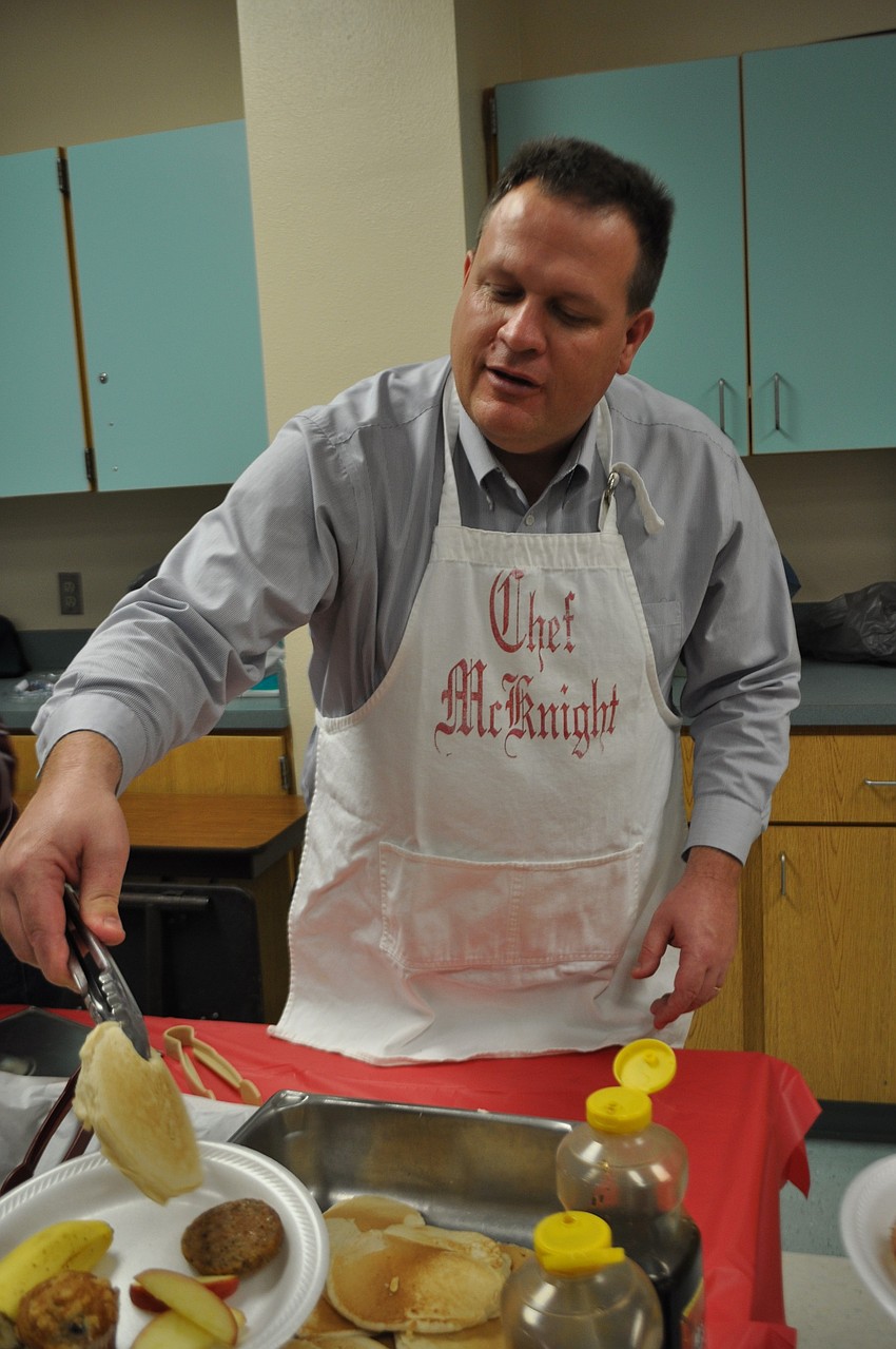 Principal Steve Royce dishes out pancakes.