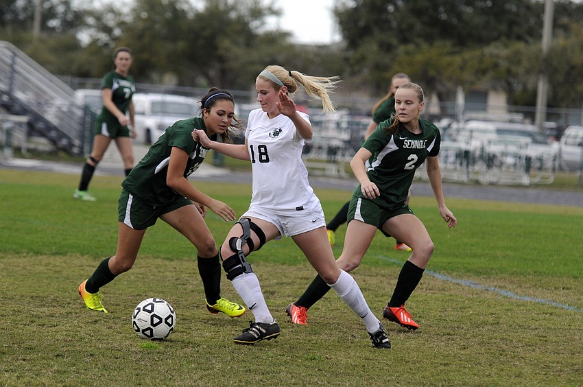 Lakewood Ranch midfielder Bri Reda maneuvers the ball past a pair of Seminole defenders early in the first half.
