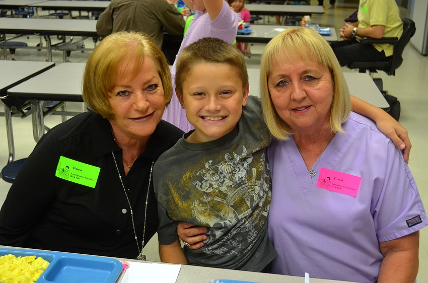 Aulden St. Lawrence, 10, sits in between grandmothers Linda Riley and Joyce St. Lawrence.