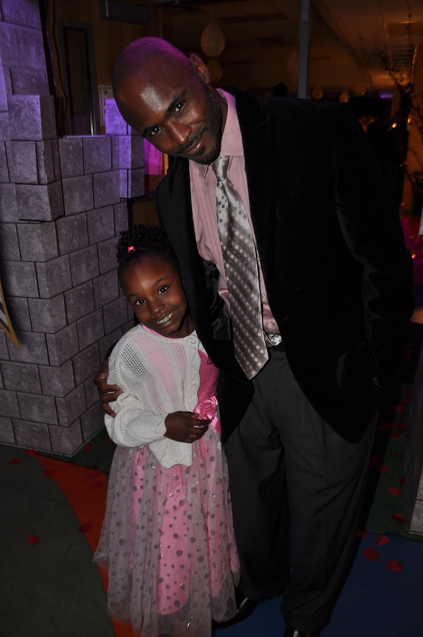 Terryn and Terrace Dunbar enter the dance through castle doors.