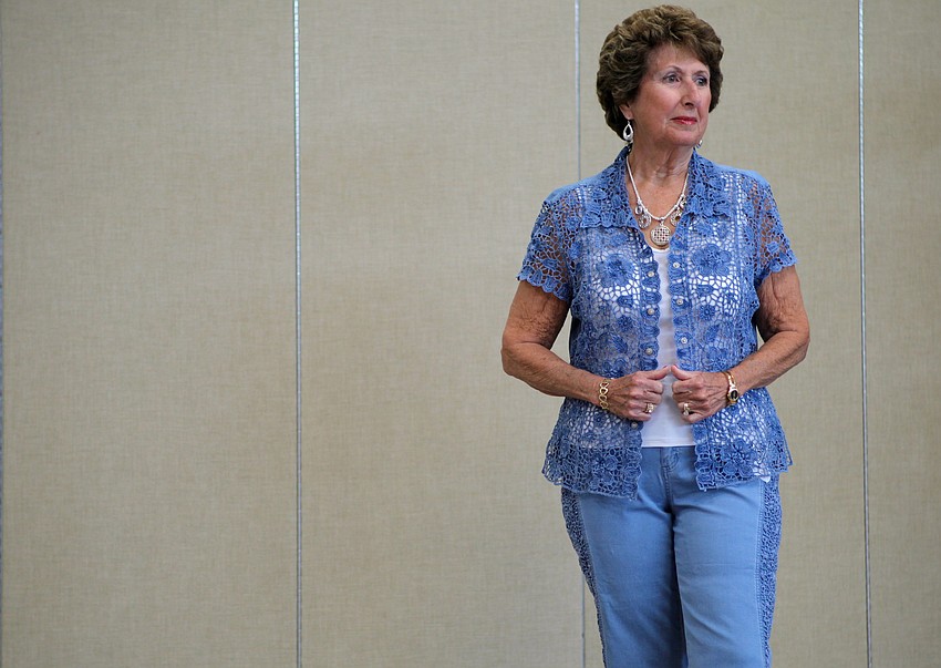 Patty Dunham wears a denim lace shirt over for her walk down the runway.