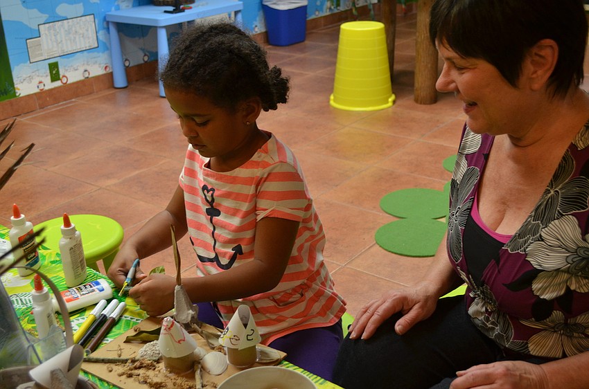 Alex Guiler and grandmother, Karen Johns, makes a fairy house.